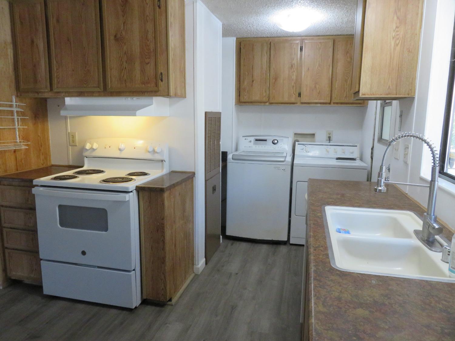 4426 Bald Mountain Road West Point, CA 95255 - Photo 25 of 45 a kitchen with a sink stove and cabinets