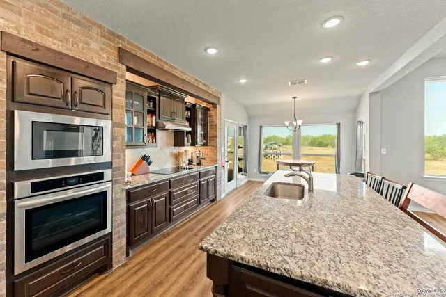 a kitchen with stainless steel appliances granite countertop a stove and a sink