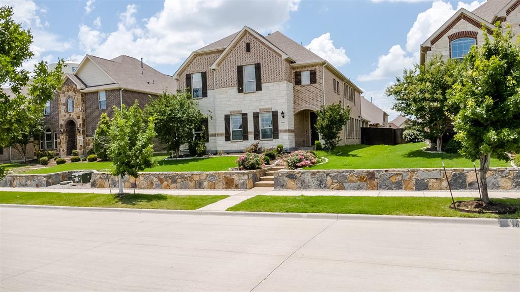 6333 Hall Road Frisco, TX 75034 - Photo 36 of 38 Two-story residence featuring a brick and stone facade with dark shutters