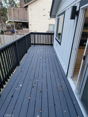 a view of outdoor space with wooden floor and metal railings