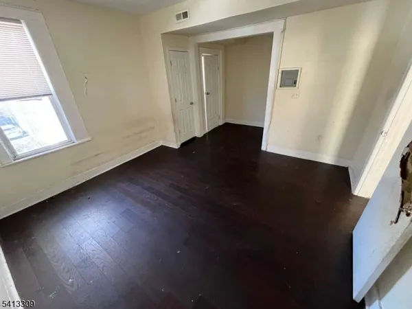 a view of room with window and wooden floor
