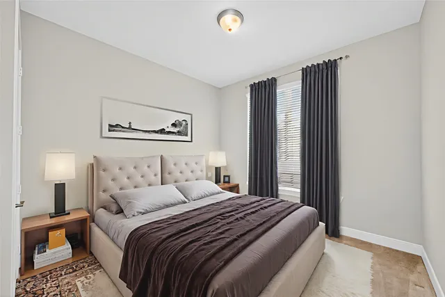 a bedroom with a large bed and a lamp