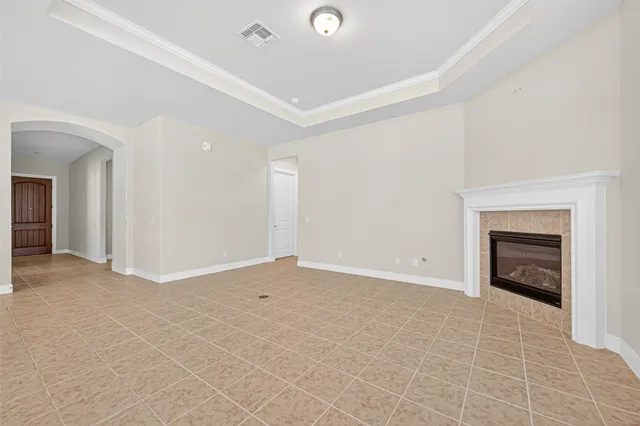 an empty room with a fireplace and a window