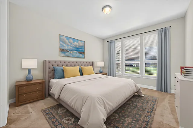 a bedroom with a large bed and a window