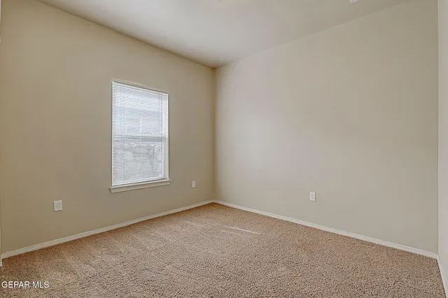 a bedroom with a large bed and a potted plant