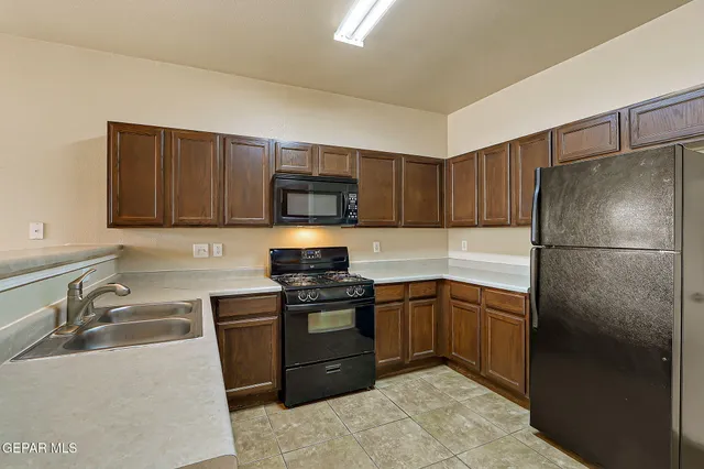 a kitchen with stainless steel appliances a stove sink microwave and cabinets