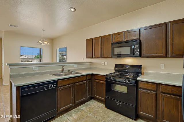 a kitchen with cabinets and stainless steel appliances