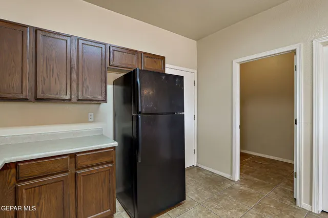 a view of an empty room with a fireplace and fan