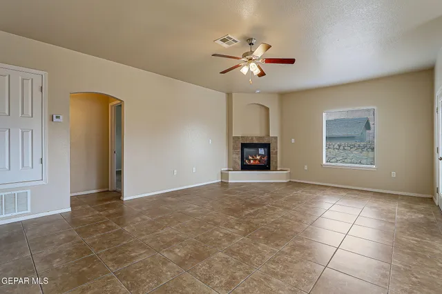 a dining room with furniture potted plants and wooden floor