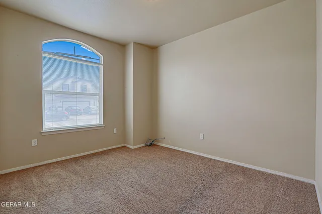 a bedroom with a bed and a potted plant