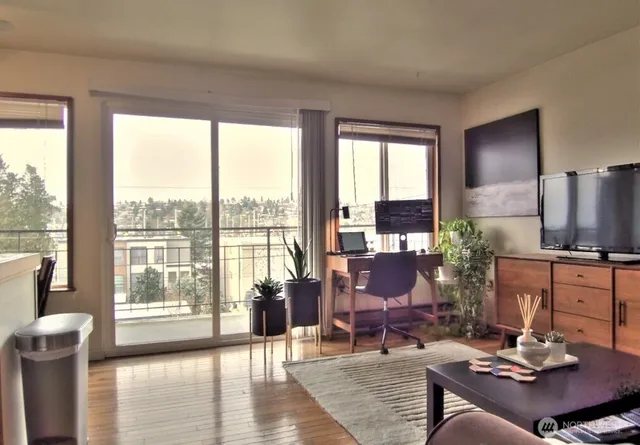 a living room with furniture large window and a table