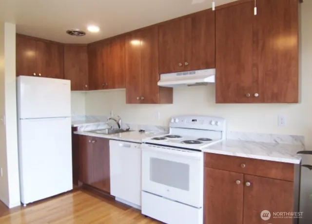 a kitchen with stainless steel appliances a stove a refrigerator and cabinets