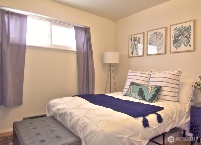 a bedroom with a bed and a window