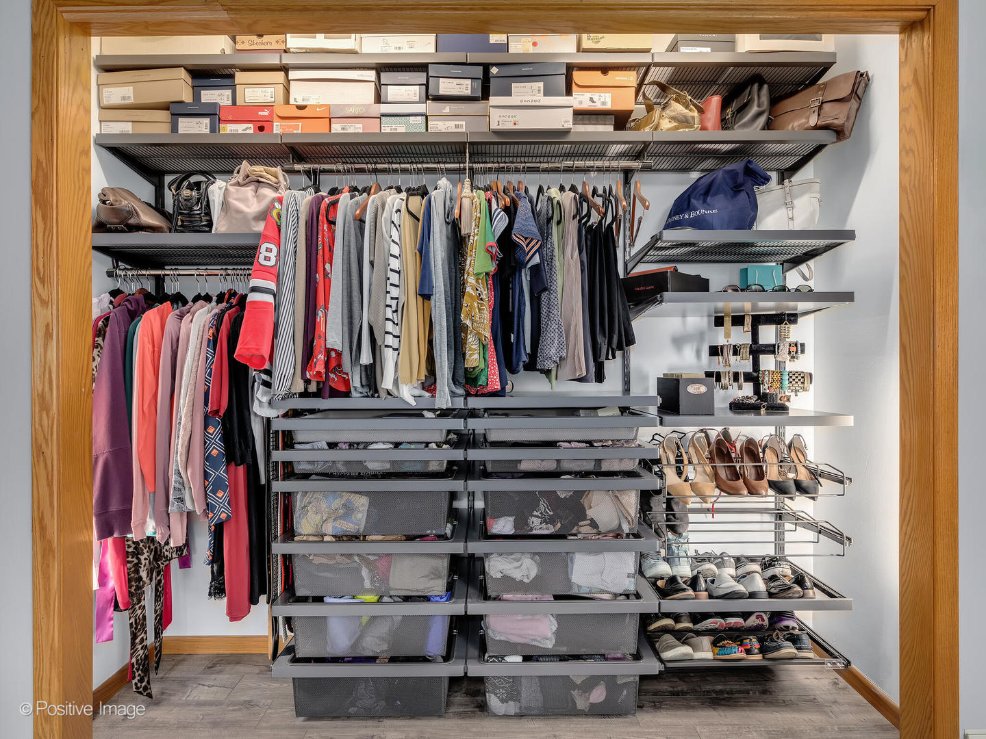 516 Camdon Circle Bartlett, IL 60103 - Photo 15 of 34 a view of walk in closet with clothes and shoes