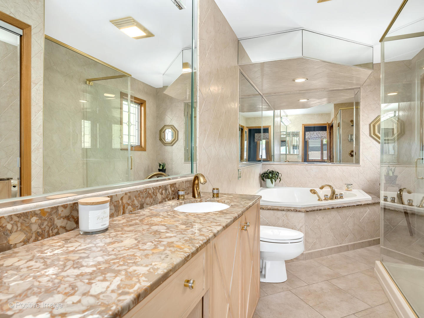 516 Camdon Circle Bartlett, IL 60103 - Photo 16 of 34 a bathroom with a granite countertop sink mirror and a bathtub