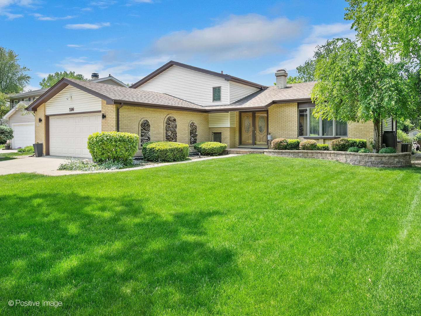 516 Camdon Circle Bartlett, IL 60103 - Photo 2 of 34 a front view of a house with a yard and porch