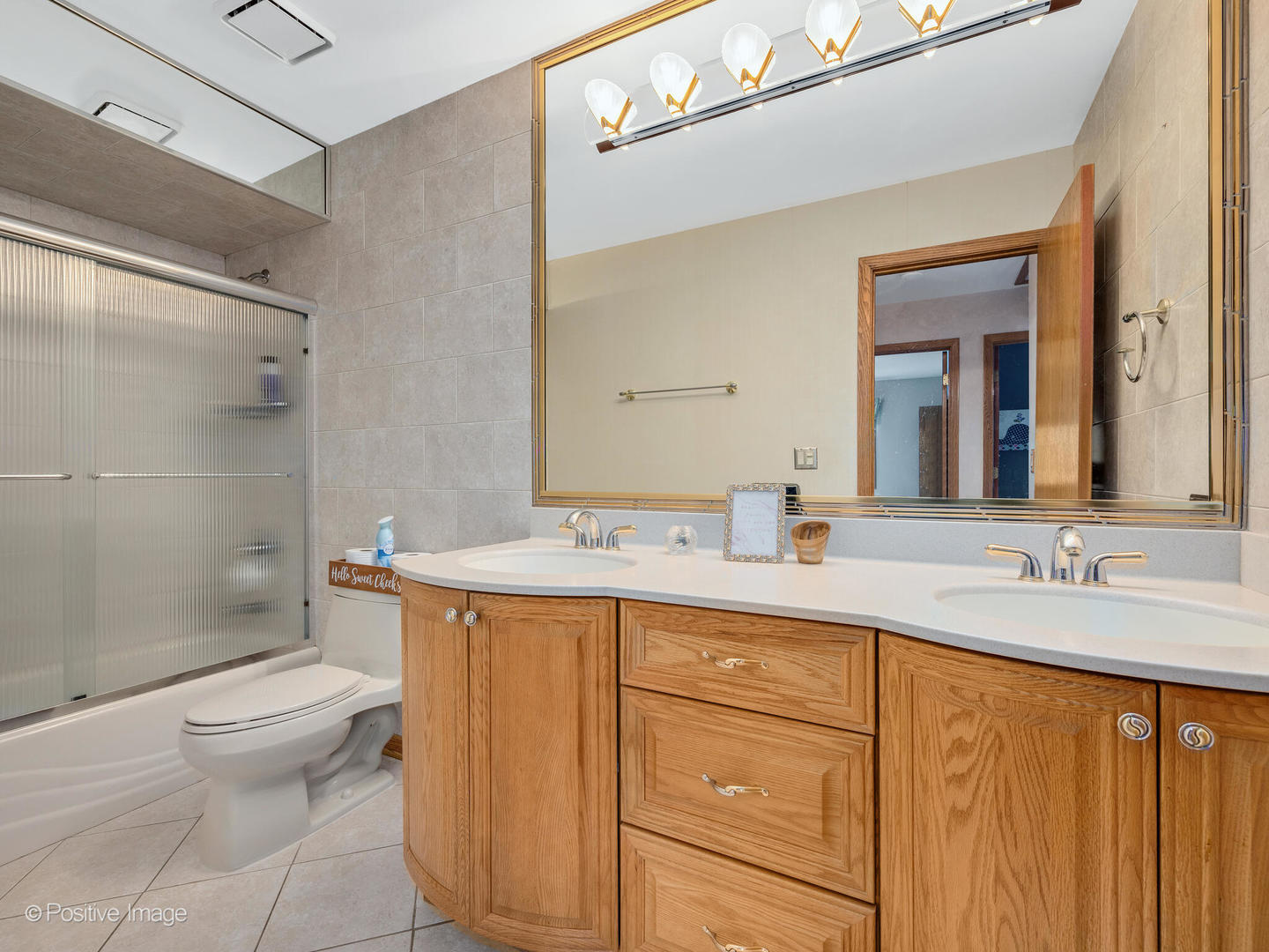 516 Camdon Circle Bartlett, IL 60103 - Photo 21 of 34 a bathroom with a double vanity sink toilet and shower