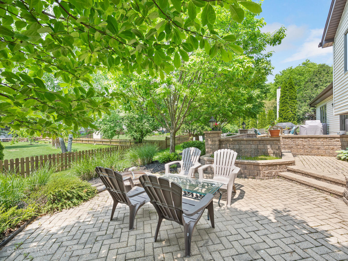 516 Camdon Circle Bartlett, IL 60103 - Photo 24 of 34 a view of a lake with a table and chairs on the deck