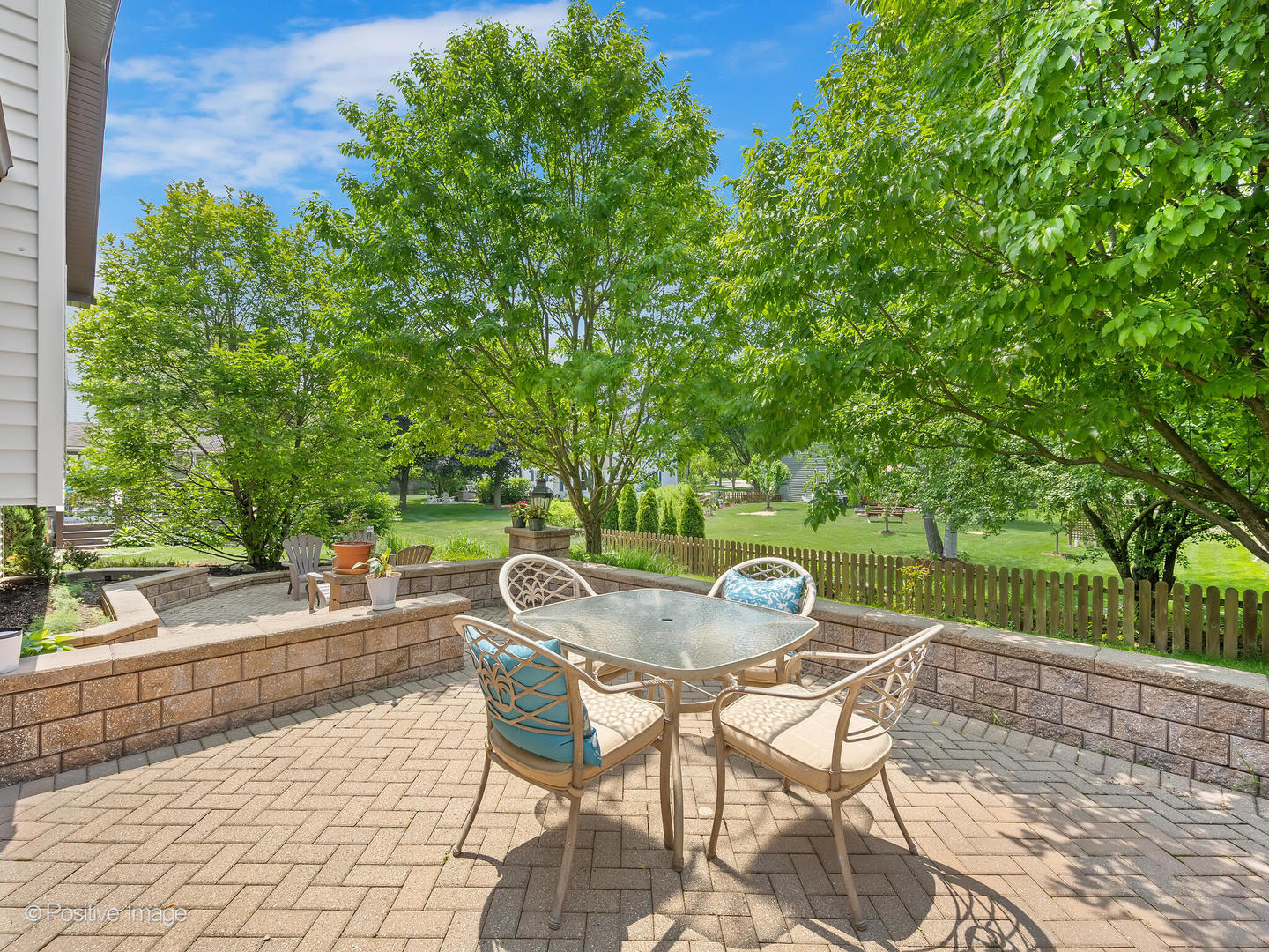 516 Camdon Circle Bartlett, IL 60103 - Photo 26 of 34 a patio with a yard table and chairs