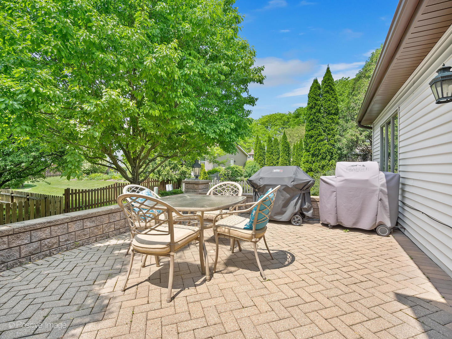 516 Camdon Circle Bartlett, IL 60103 - Photo 27 of 34 a patio with table and chairs and potted plants