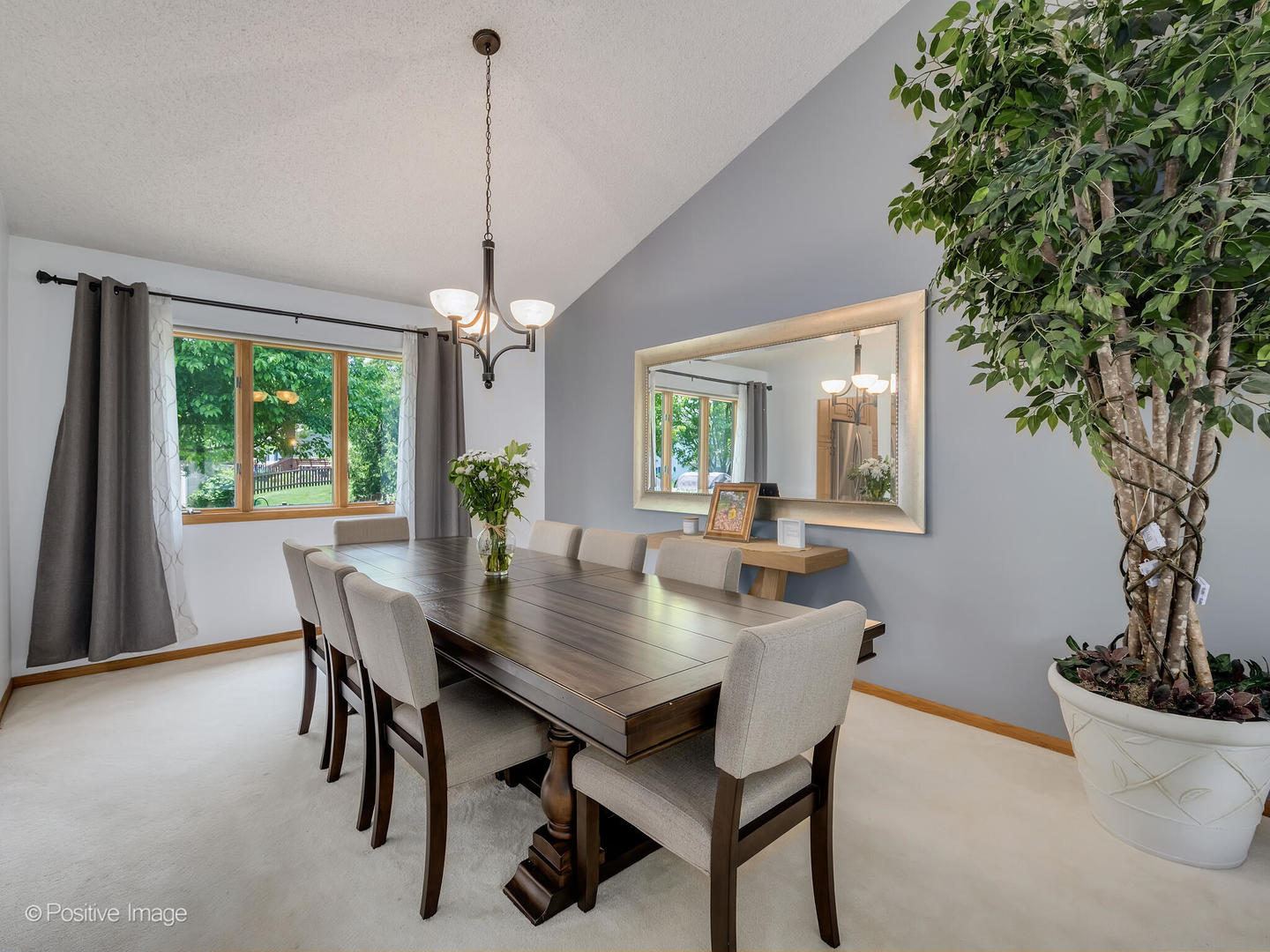 516 Camdon Circle Bartlett, IL 60103 - Photo 5 of 34 a dining room with furniture wooden floor a potted plant and a chandelier