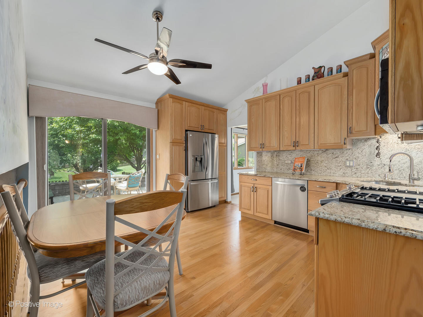 516 Camdon Circle Bartlett, IL 60103 - Photo 8 of 34 a kitchen with granite countertop a stove a sink dishwasher a kitchen island with a dining table and chairs