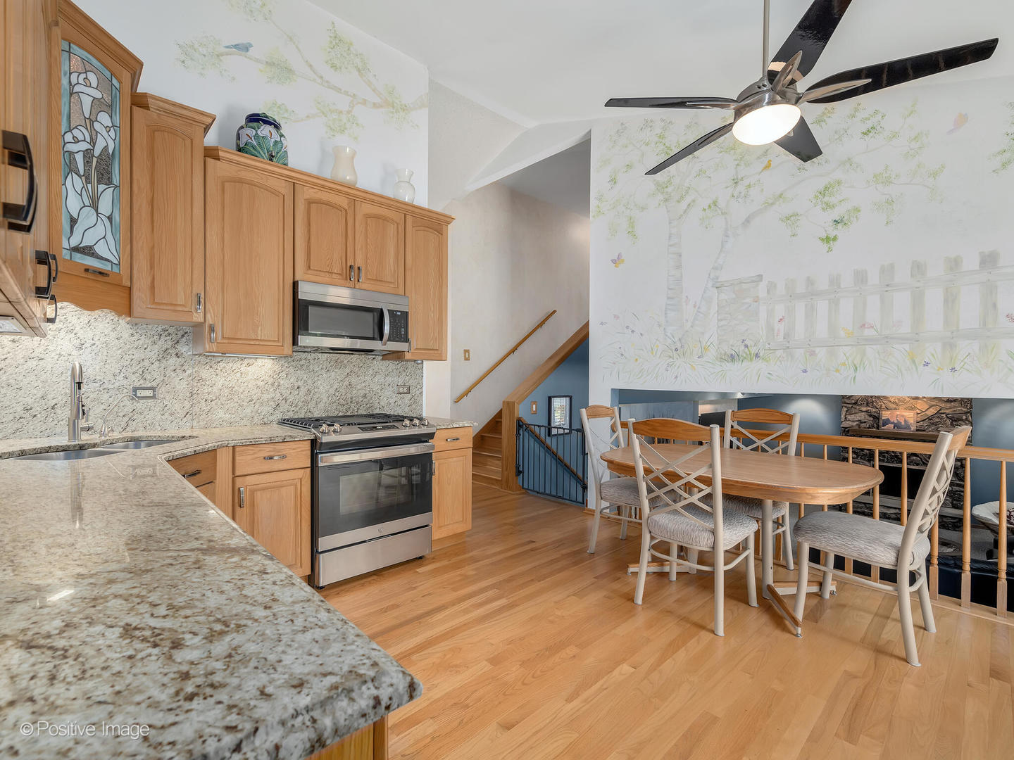 516 Camdon Circle Bartlett, IL 60103 - Photo 10 of 34 a kitchen with a table chairs microwave and cabinets