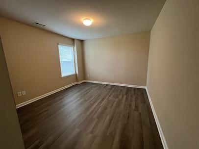 3829 Baxley Ridge Drive Suwanee, GA 30024 - Photo 8 of 11 an empty room with wooden floor and windows