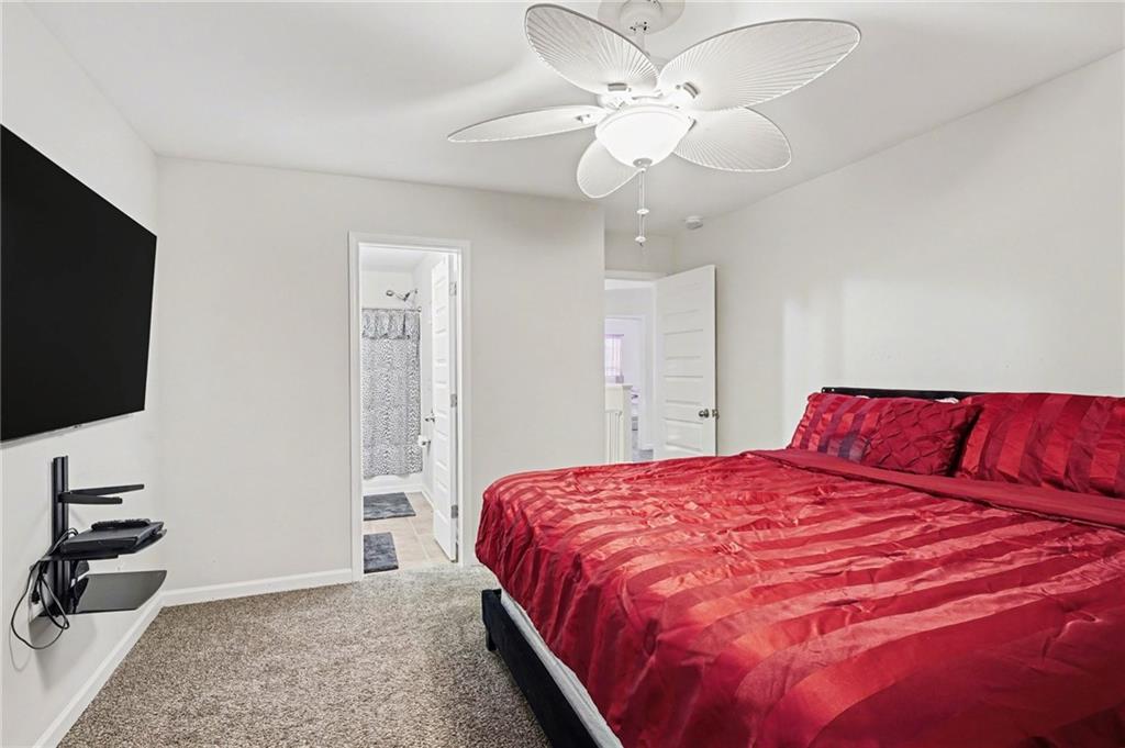 1241 England Terrace Hampton, GA 30228 - Photo 12 of 20 a bedroom with a large bed and a flat screen tv