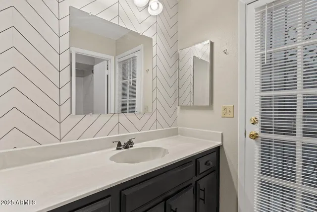 a bathroom with a sink and a mirror