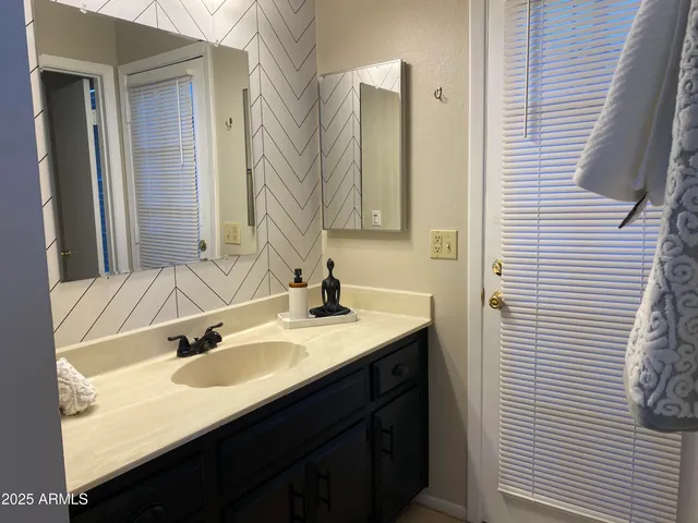 a white bath tub sitting next to a white toilet and a shower