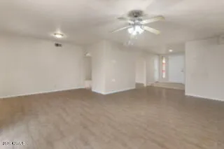 a view of a livingroom with a ceiling fan and window