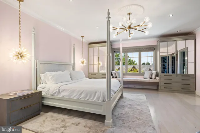 a bedroom with a bed wooden floor and a chandelier