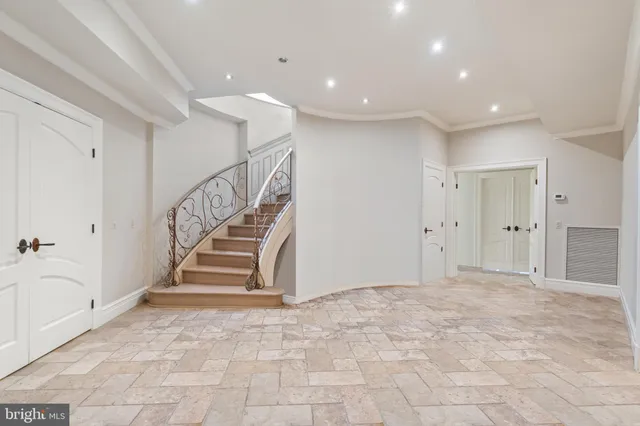 a bedroom with a bed next to a large window