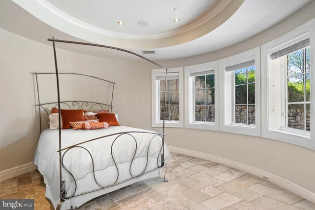 a view of a patio with table and chairs potted plants and floor to ceiling window