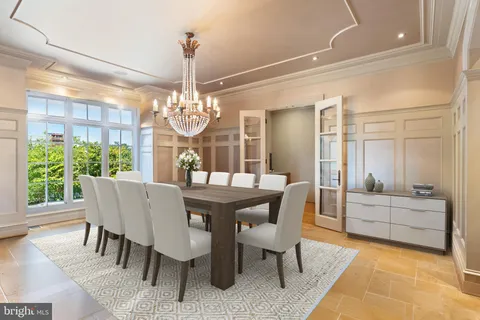 a dining table with chairs and window