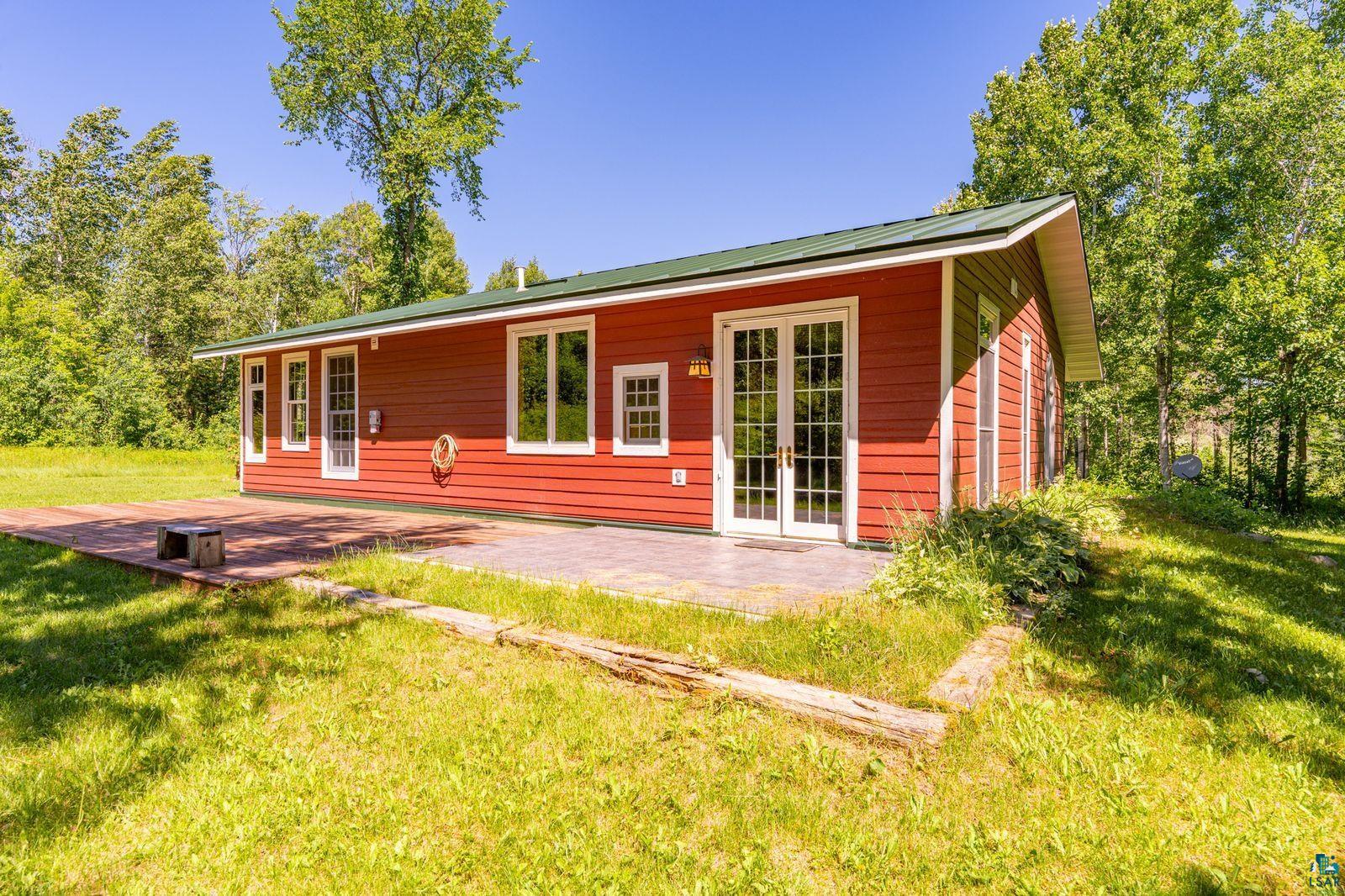 9734 Alango Road Angora, MN 55703 - Photo 26 of 41 Red exterior siding with a dark green roof