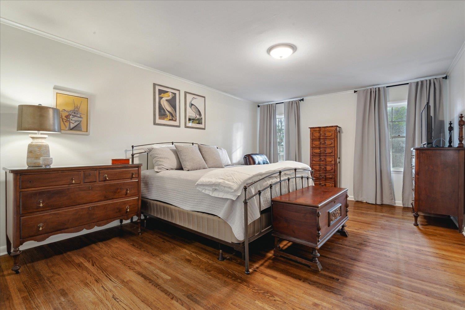 5419 Walnut Grove Road Memphis, TN 38120 - Photo 16 of 29 a bedroom with a bed and wooden floor