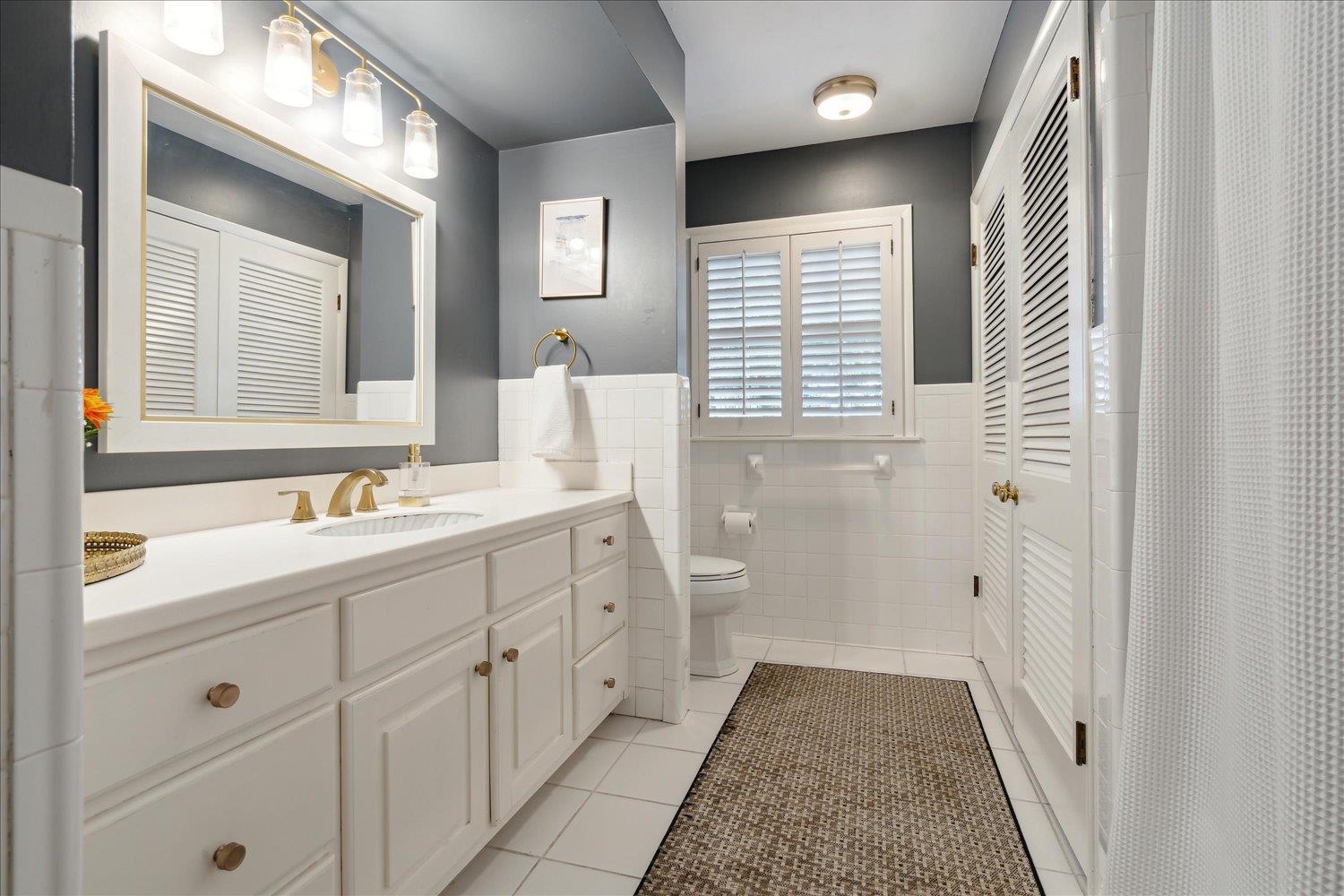 5419 Walnut Grove Road Memphis, TN 38120 - Photo 20 of 29 a bathroom with a sink a mirror and a shower