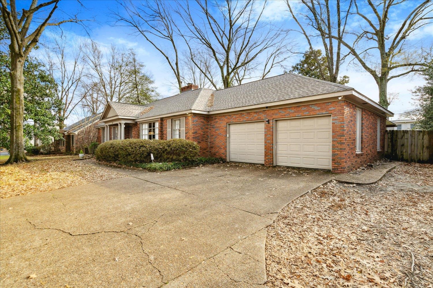 5419 Walnut Grove Road Memphis, TN 38120 - Photo 3 of 29 a front view of house with yard and trees around