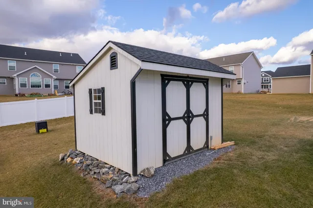 a view of a house with swimming pool and sitting area