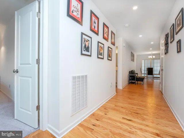 a kitchen with stainless steel appliances granite countertop a refrigerator sink and white cabinets