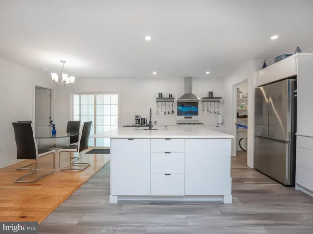 a kitchen with a stove a sink and a refrigerator