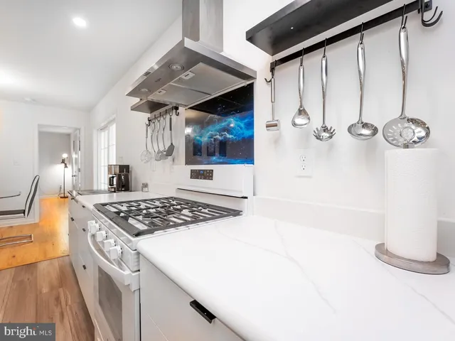 a kitchen with stainless steel appliances a sink stove and refrigerator