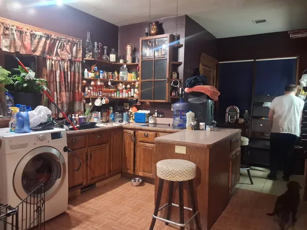 a kitchen with a sink a stove and chairs