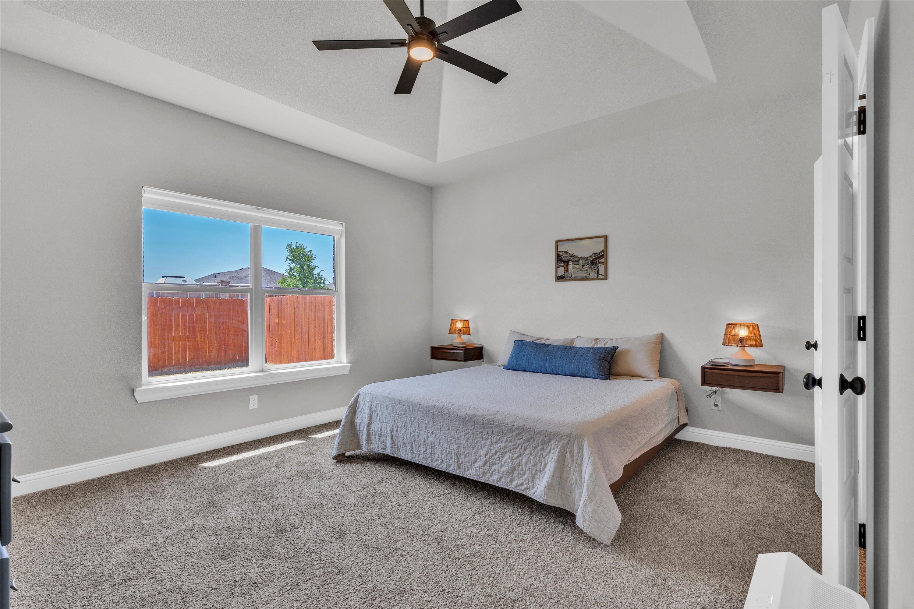 6803 52nd Street Lubbock, TX 79407 - Photo 11 of 34 a bedroom with a bed and a window