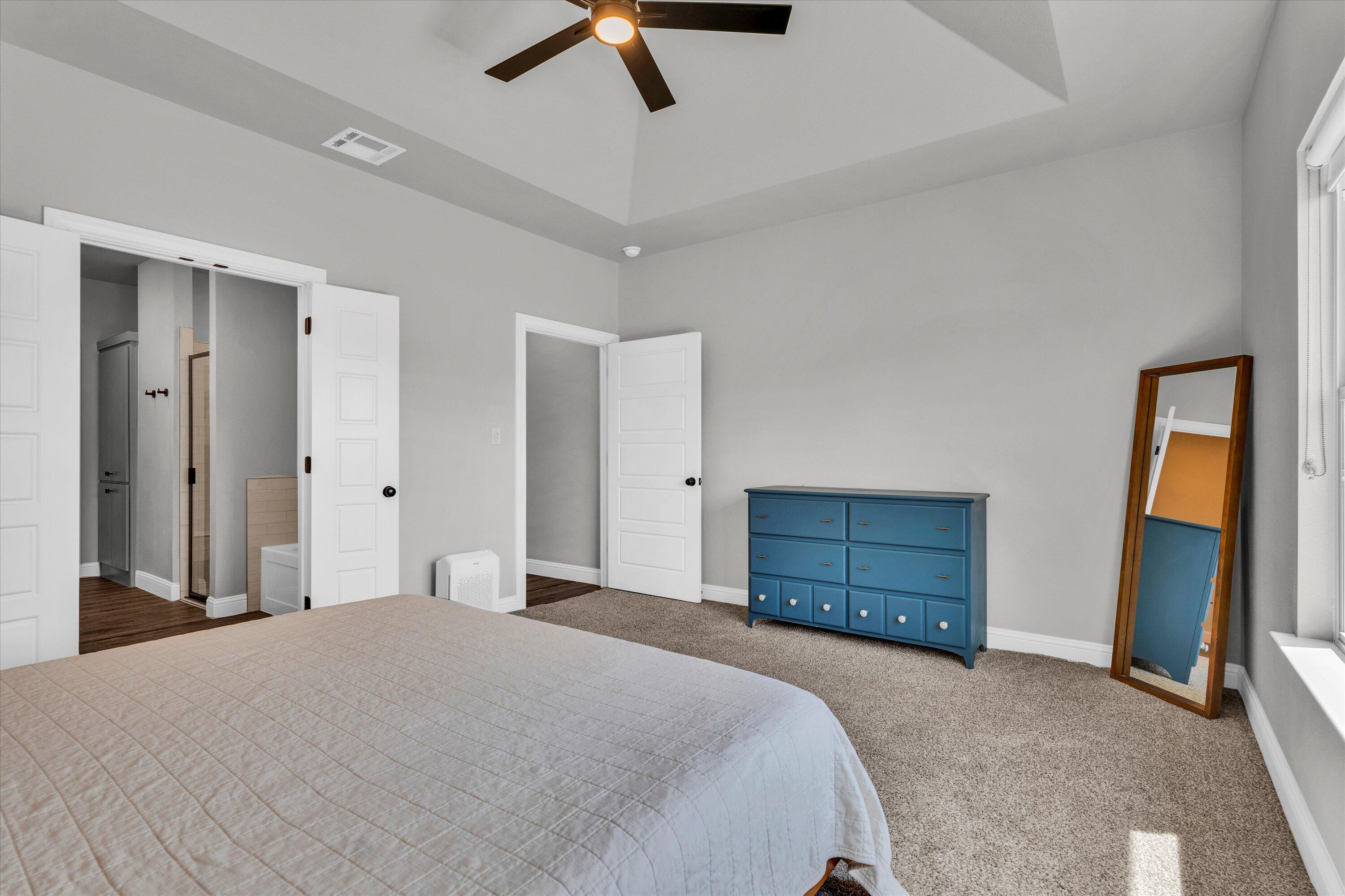6803 52nd Street Lubbock, TX 79407 - Photo 12 of 34 a bedroom with a bed and a dresser