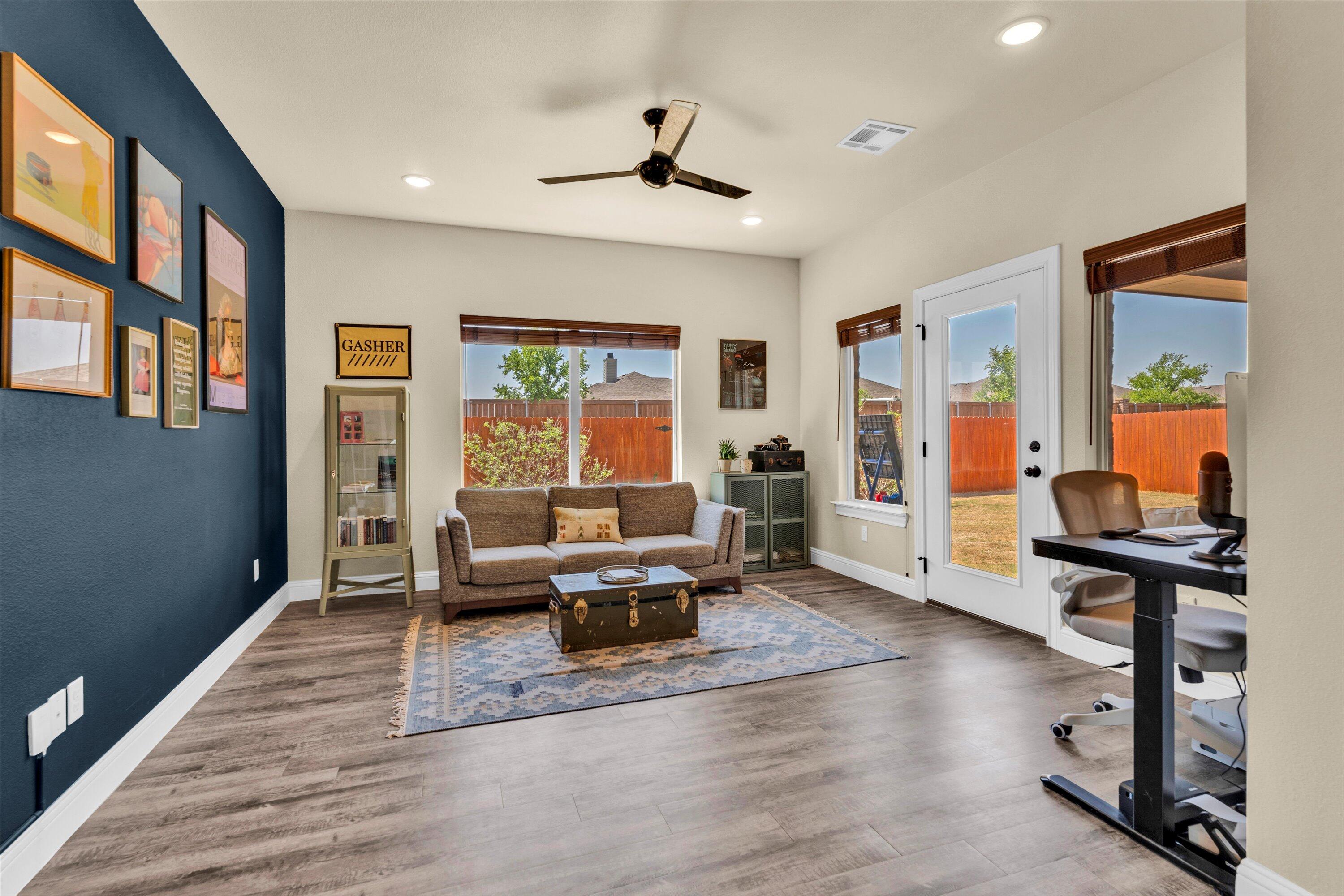 6803 52nd Street Lubbock, TX 79407 - Photo 19 of 34 a living room with furniture window and wooden floor