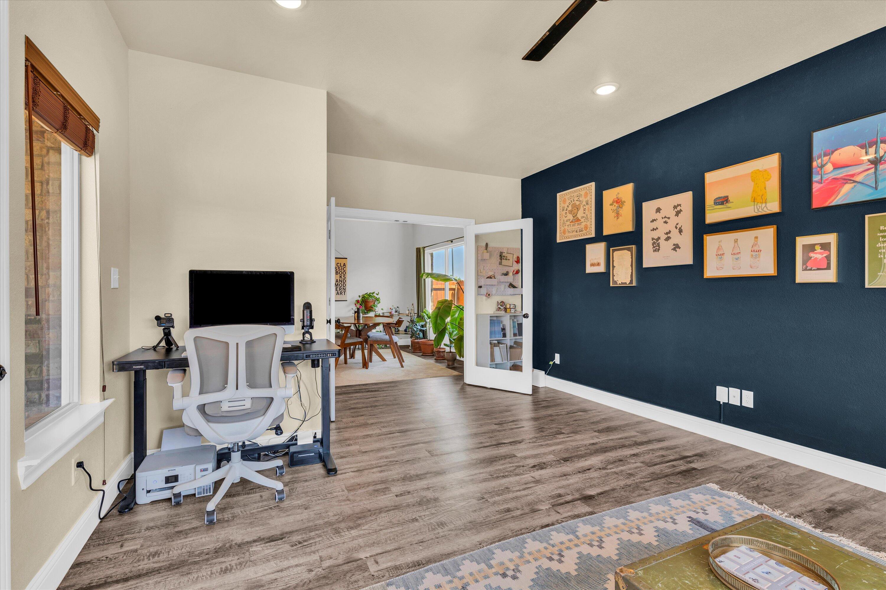 6803 52nd Street Lubbock, TX 79407 - Photo 20 of 34 a living room with furniture and a flat screen tv