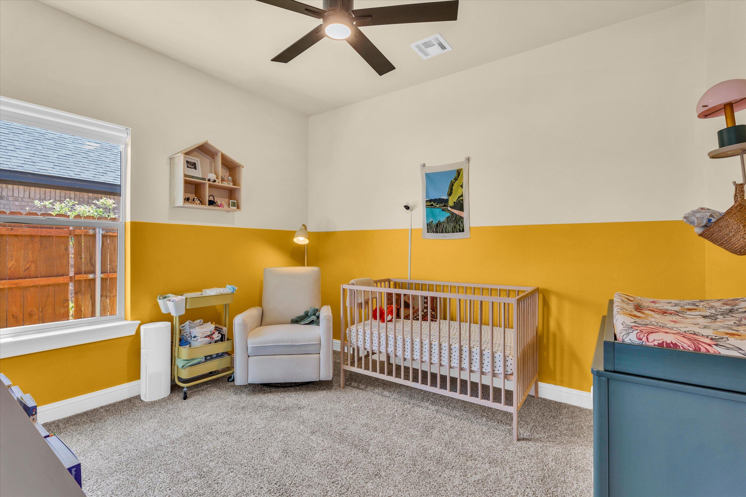 6803 52nd Street Lubbock, TX 79407 - Photo 21 of 34 a bedroom with furniture and a window